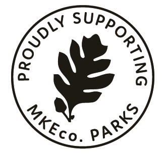 A circular logo with a leaf in the center and the text "PROUDLY SUPPORTING MKEco. PARKS" around the edge.