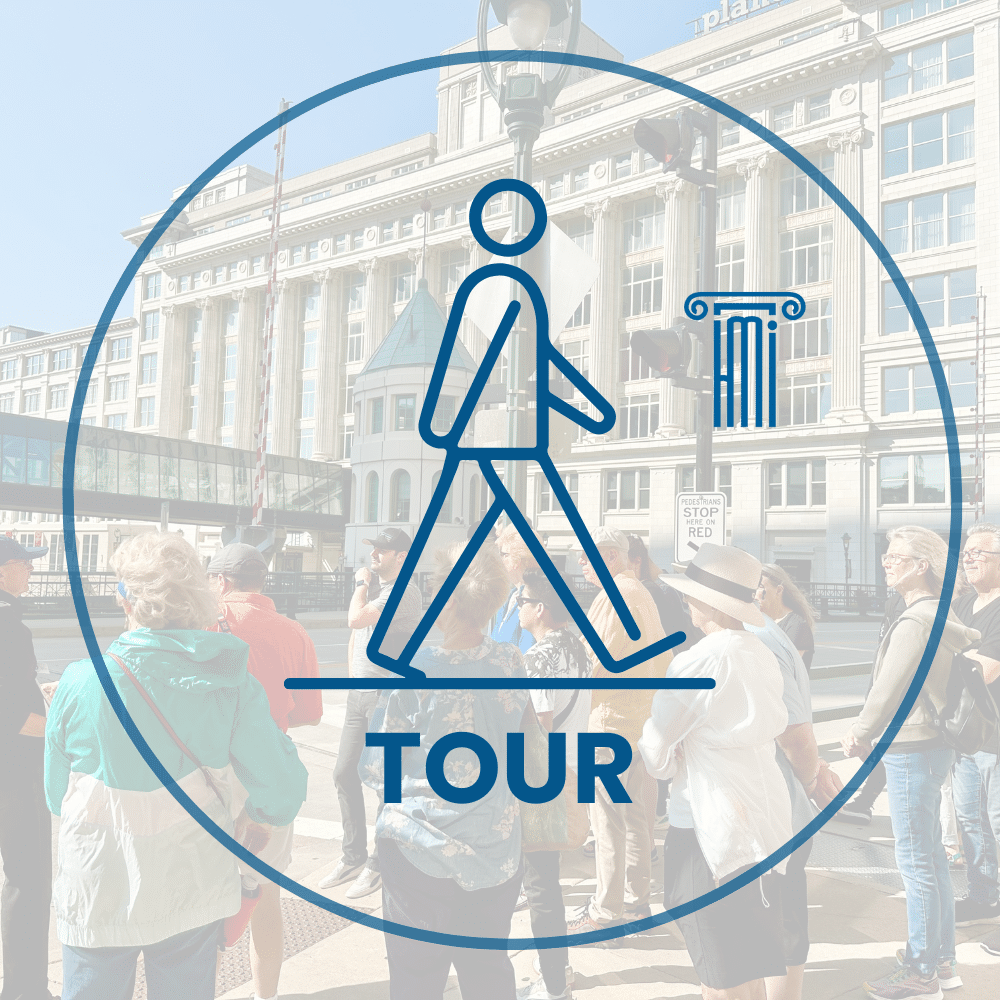 A group of people stands outside a large building, overlaid with a blue walking tour icon and the word "TOUR.